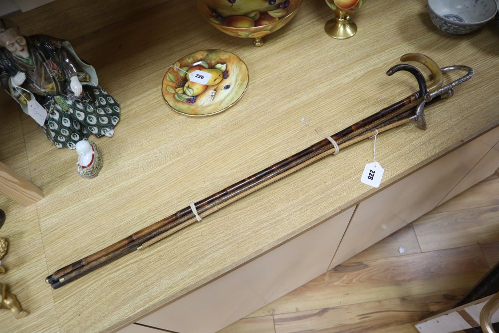 Four various walking canes and a fish pointer